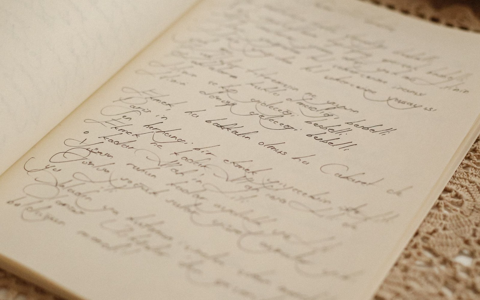 Open notebook page filled with handwritten cursive notes in ink